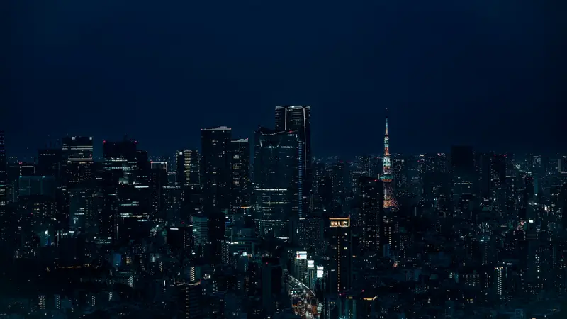 Vue nocturne de Tokyo, avec ses gratte-ciel éclairés et la tour de Tokyo illuminée