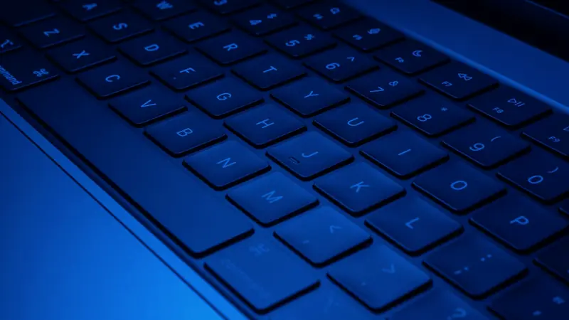 Clavier d'ordinateur portable éclairé en bleu, vu en gros plan